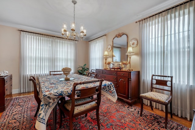 1540 Isabel Ct, Tallahassee, FL 32303 - dining area featuring a chandelier, plenty of natural light, light wood-style floors, and ornamental molding