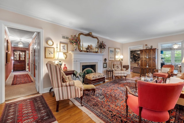 1540 Isabel Ct, Tallahassee, FL 32303 - living room featuring wood finished floors, a fireplace, and ornamental molding