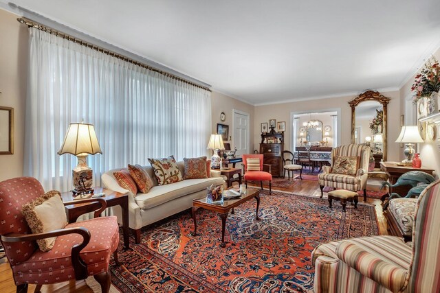 1540 Isabel Ct, Tallahassee, FL 32303 - living room featuring a chandelier, wood finished floors, and crown molding