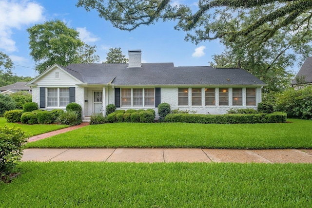 1540 Isabel Ct, Tallahassee, FL 32303 - view of front facade with a front lawn, a chimney, and brick siding