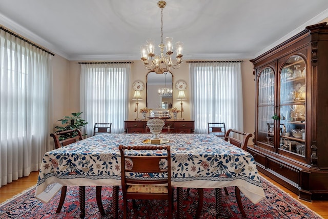 1540 Isabel Ct, Tallahassee, FL 32303 - dining space with a chandelier, crown molding, and light wood-type flooring