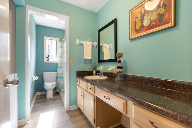 bathroom with vanity, toilet, and tile patterned flooring