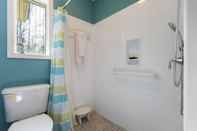 bathroom with a shower with curtain and toilet