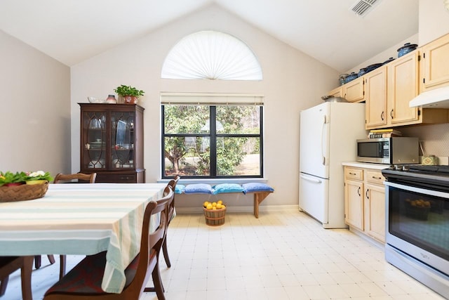 kitchen featuring vaulted ceiling, stainless steel appliances, and light brown cabinets