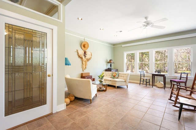 living area featuring light tile patterned flooring and ceiling fan