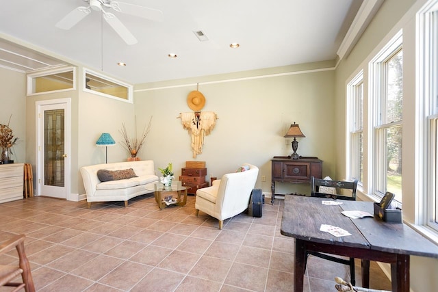 interior space featuring light tile patterned flooring, ceiling fan, and crown molding