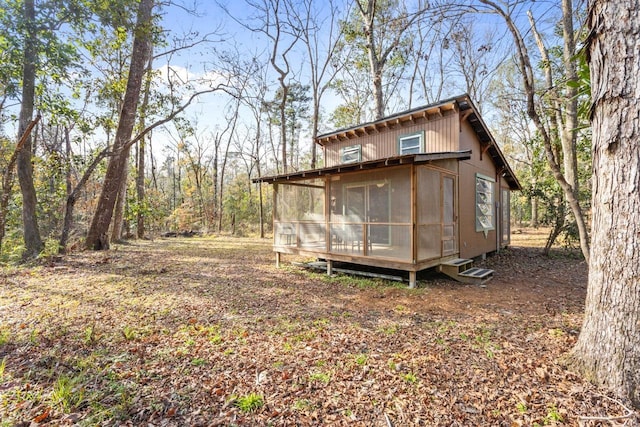 view of outdoor structure featuring a sunroom