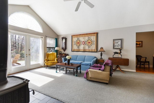 carpeted living room featuring high vaulted ceiling, french doors, and ceiling fan