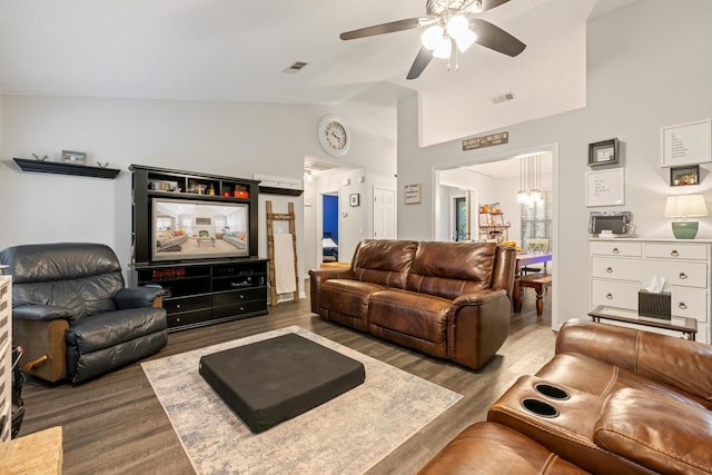 living room featuring ceiling fan with notable chandelier, dark hardwood / wood-style flooring, and lofted ceiling