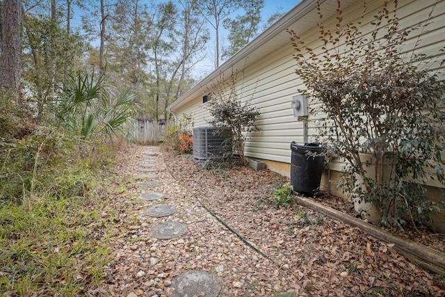 view of side of home featuring central AC unit