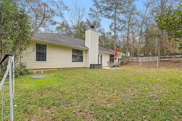 rear view of house featuring a patio and a lawn