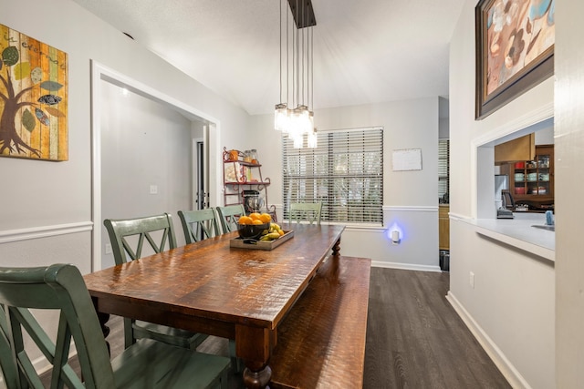 dining space featuring a notable chandelier and dark hardwood / wood-style floors