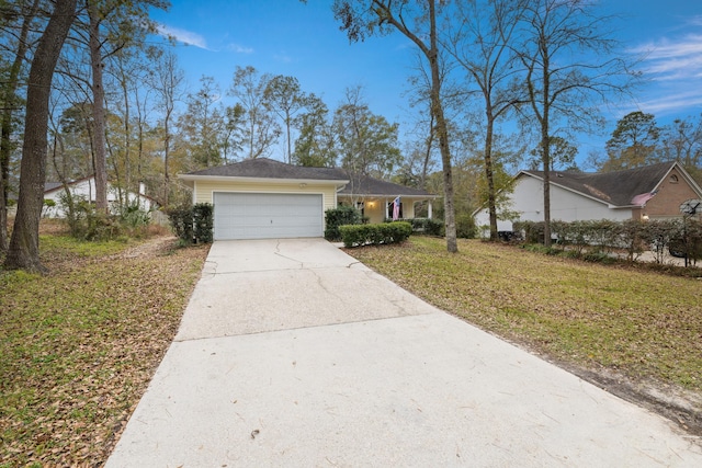 single story home with a garage and a front lawn