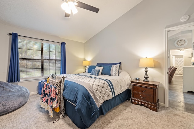 carpeted bedroom with vaulted ceiling and ceiling fan