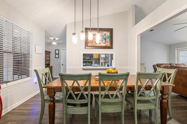 dining area with sink, vaulted ceiling, and dark wood-type flooring