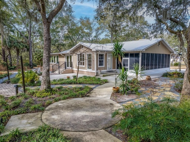 view of front facade with a sunroom