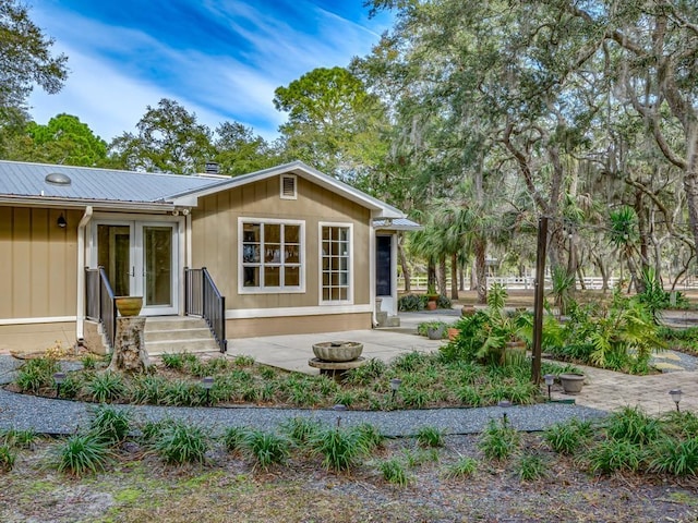 exterior space featuring french doors, a patio area, and an outdoor fire pit