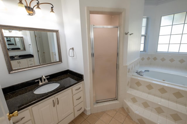 bathroom with tile patterned floors, vanity, and independent shower and bath