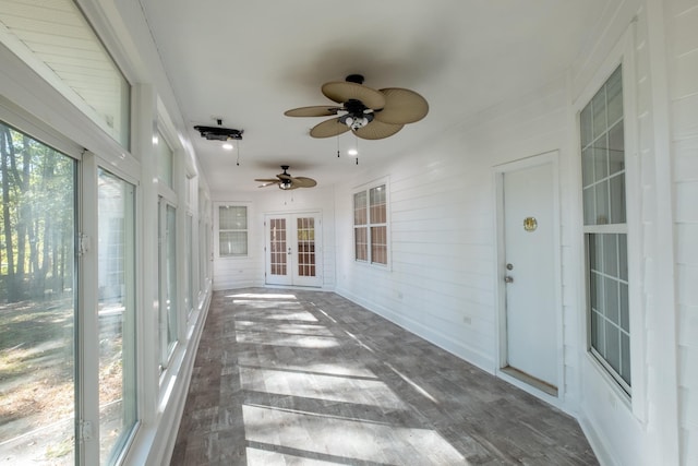 unfurnished sunroom featuring french doors and ceiling fan