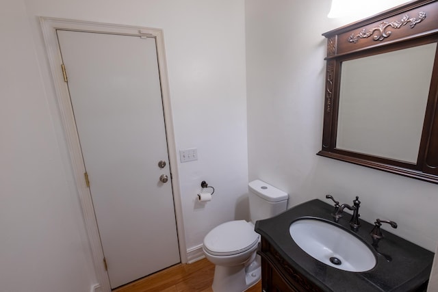 bathroom featuring hardwood / wood-style floors, vanity, and toilet