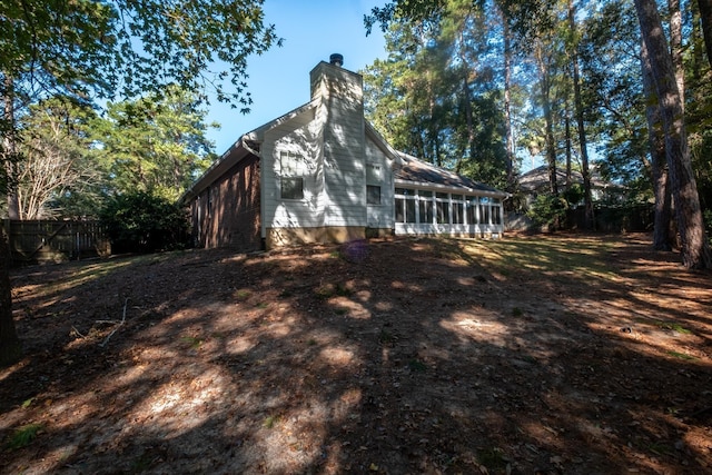 view of property exterior featuring a sunroom