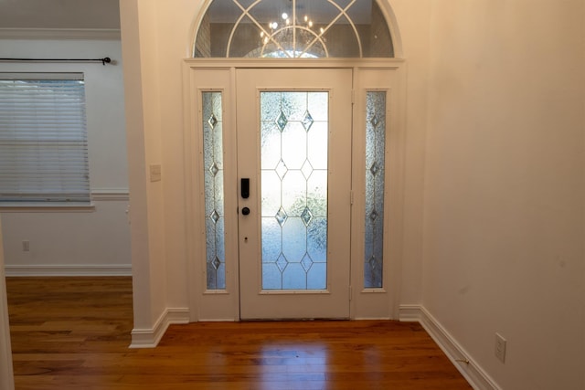 foyer with a notable chandelier and dark wood-type flooring