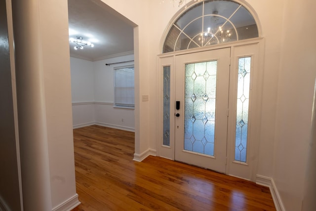 foyer with dark hardwood / wood-style flooring and ornamental molding