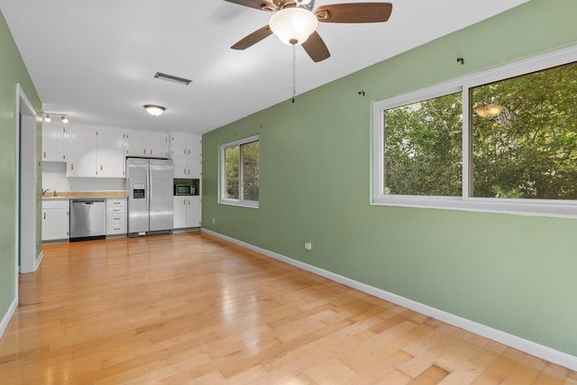 1233 Talbot Ave, Tallahassee, FL 32308 - unfurnished living room featuring healthy amount of natural light, baseboards, light wood-style flooring, and a ceiling fan