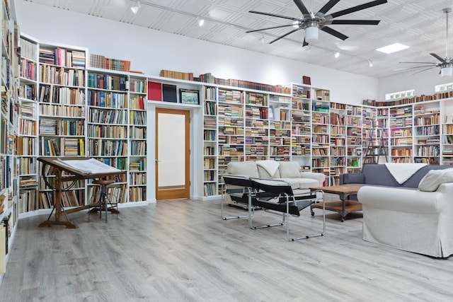 sitting room with hardwood / wood-style flooring and ceiling fan