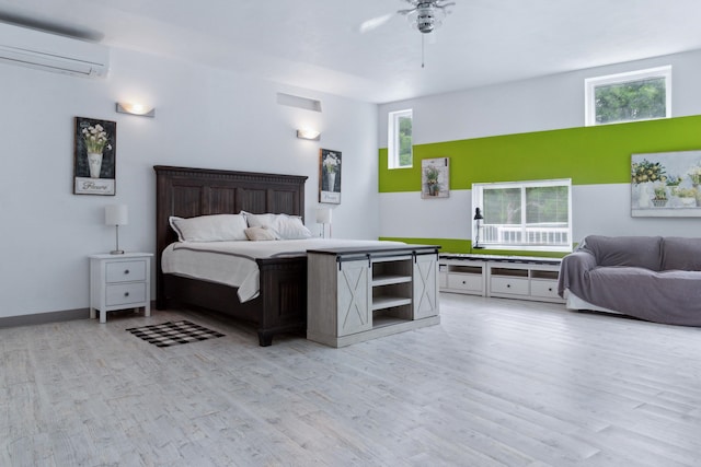 bedroom with ceiling fan, multiple windows, and an AC wall unit