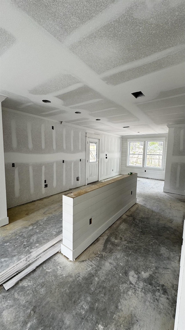 empty room featuring a wealth of natural light, visible vents, and a textured ceiling