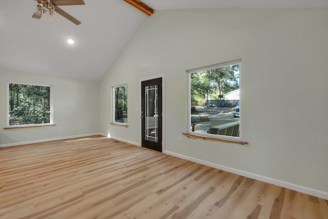 unfurnished room with ceiling fan, beam ceiling, light wood-type flooring, and high vaulted ceiling