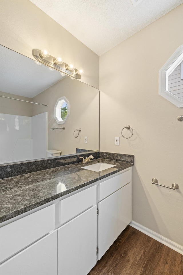 3068 Royal Palm Way, Tallahassee, FL 32309 - bathroom with vanity, wood finished floors, a shower, baseboards, and toilet
