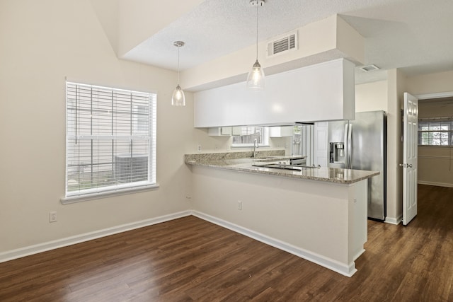 3068 Royal Palm Way, Tallahassee, FL 32309 - kitchen with stainless steel fridge with ice dispenser, a peninsula, dark wood-style flooring, light stone counters, and a textured ceiling