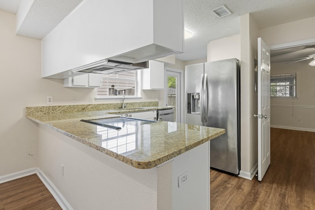 3068 Royal Palm Way, Tallahassee, FL 32309 - kitchen featuring stainless steel appliances, a peninsula, dark wood finished floors, light stone countertops, and white cabinets