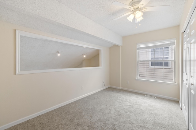3068 Royal Palm Way, Tallahassee, FL 32309 - empty room featuring carpet flooring, ceiling fan, a textured ceiling, baseboards, and vaulted ceiling