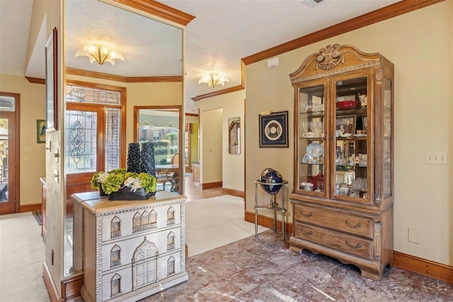 carpeted foyer with ornamental molding