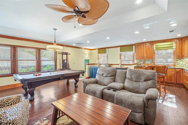 living room with billiards, dark hardwood / wood-style floors, a wealth of natural light, and a tray ceiling