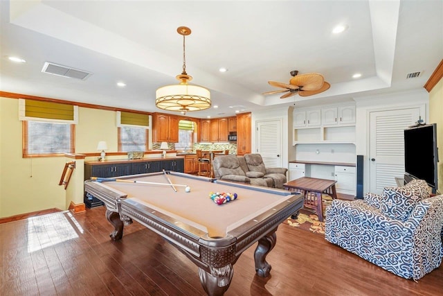 rec room with crown molding, billiards, ceiling fan, hardwood / wood-style floors, and a tray ceiling