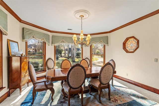 carpeted dining area featuring crown molding, a healthy amount of sunlight, and an inviting chandelier