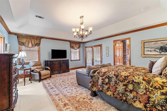 carpeted bedroom featuring a raised ceiling, ornamental molding, and an inviting chandelier