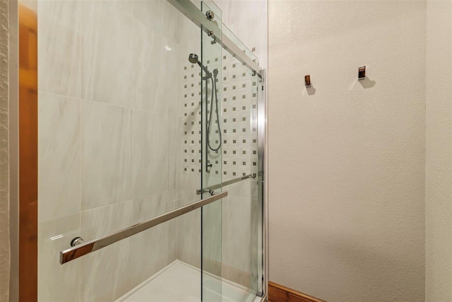 bathroom featuring a shower with shower door