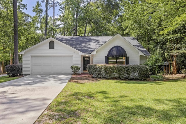 8352 Chickasaw Trl, Tallahassee, FL 32312 - ranch-style house featuring an attached garage, driveway, a front lawn, a shingled roof, and view of wooded area