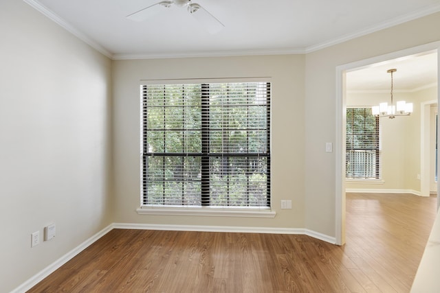 8352 Chickasaw Trl, Tallahassee, FL 32312 - spare room featuring healthy amount of natural light, a ceiling fan, a chandelier, wood finished floors, and ornamental molding