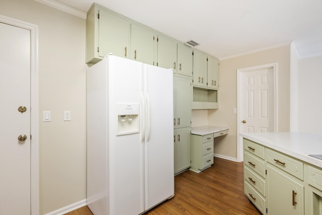 8352 Chickasaw Trl, Tallahassee, FL 32312 - kitchen with white refrigerator with ice dispenser, ornamental molding, dark wood-style flooring, baseboards, and light countertops