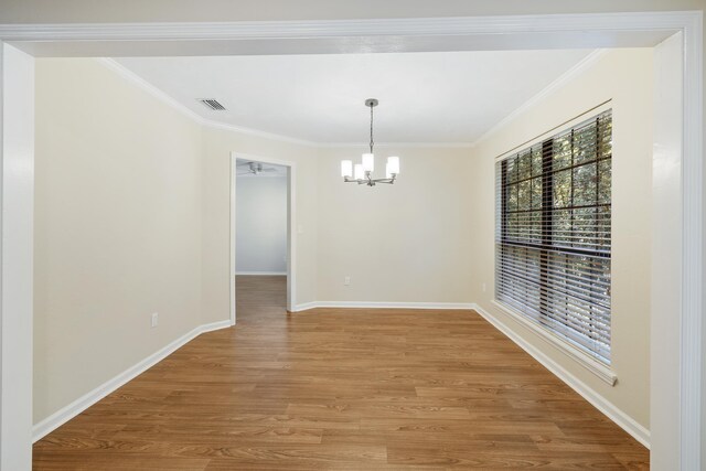 8352 Chickasaw Trl, Tallahassee, FL 32312 - unfurnished dining area with a chandelier, light wood-style floors, crown molding, and baseboards