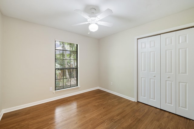 8352 Chickasaw Trl, Tallahassee, FL 32312 - unfurnished bedroom with wood finished floors, baseboards, a closet, and ceiling fan