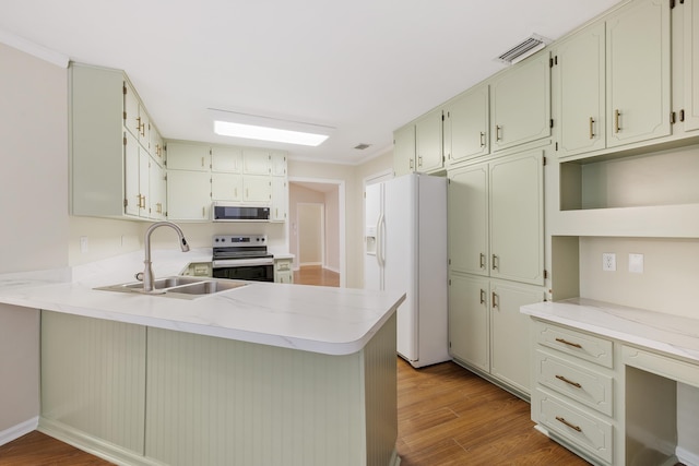 8352 Chickasaw Trl, Tallahassee, FL 32312 - kitchen featuring electric range, a sink, white refrigerator with ice dispenser, a peninsula, and wood finished floors