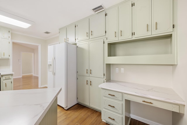 8352 Chickasaw Trl, Tallahassee, FL 32312 - kitchen featuring white refrigerator with ice dispenser, light wood-style floors, crown molding, open shelves, and light stone counters