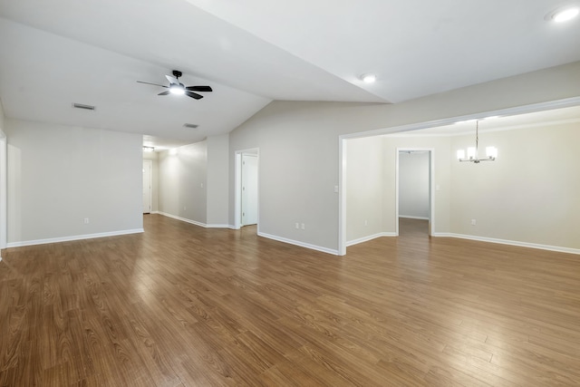 8352 Chickasaw Trl, Tallahassee, FL 32312 - spare room with a chandelier, a ceiling fan, lofted ceiling, wood finished floors, and baseboards